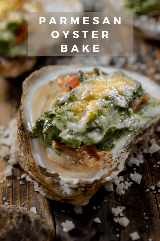 Parmesan topped oyster in the half shell placed on a bed of sea salt