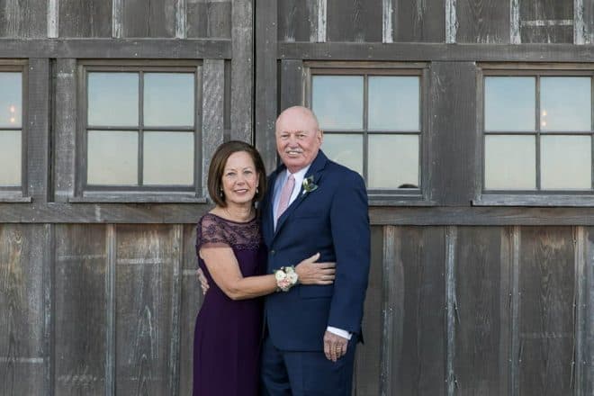 my brother and sister-in-law, Patty, standing in front of a barn