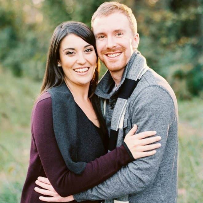 Photo of a couple placing their hands in the proper place for a photo