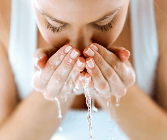 makeup tips for women over 50 - woman washing face over sink