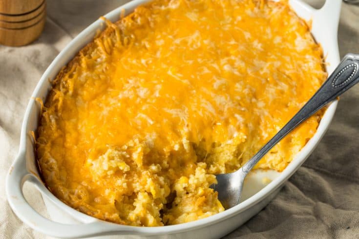 Mexican Corn Casserole in White Dish With Spoon