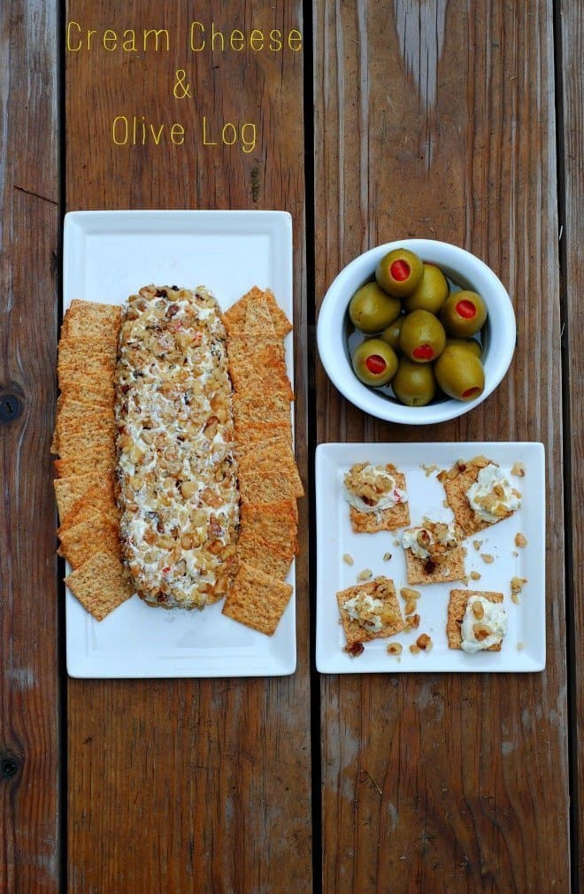 Walnut Olive Cheese Loaf served with crackers on white platter