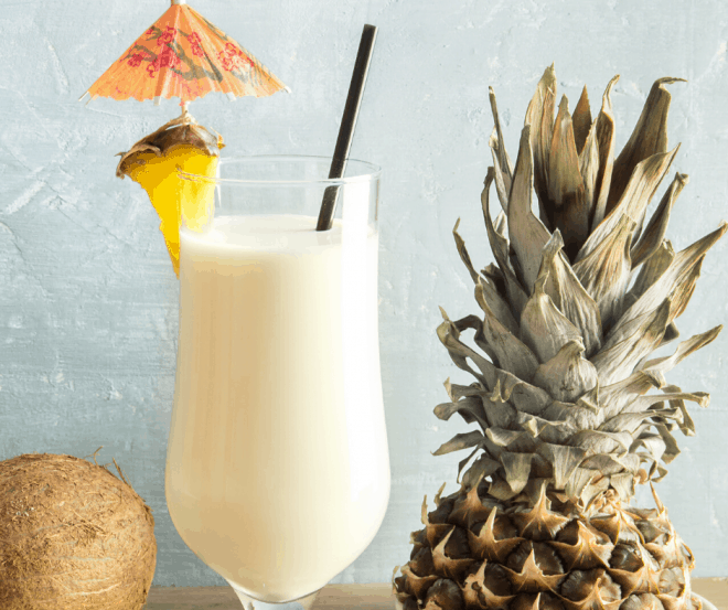 Breakfast Pina Colada in tall glass garnished with pineapple wedge and umbrella