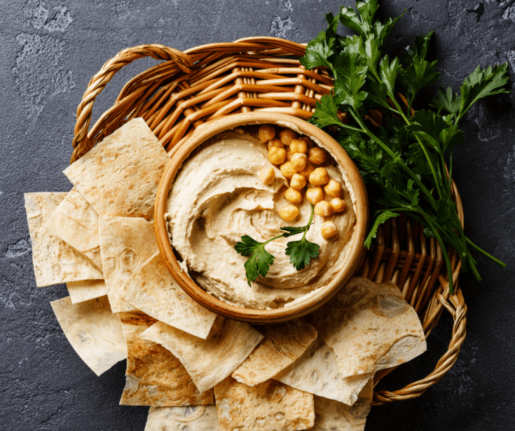 Easy Homemade Hummus served with pita chips in a basket