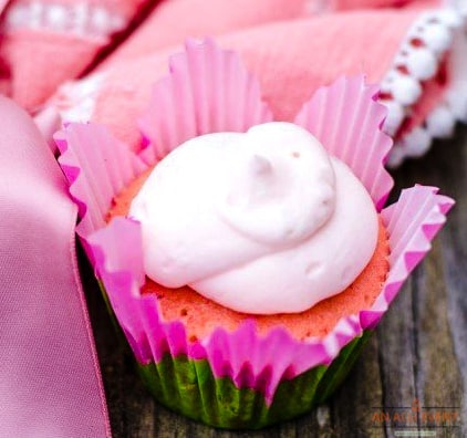 One Strawberry Cupcake topped with a strawberry lemonade frosting in pink wrapper