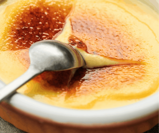 Closeup Photo of sugar breaking on top of Coconut Crème Brûlée