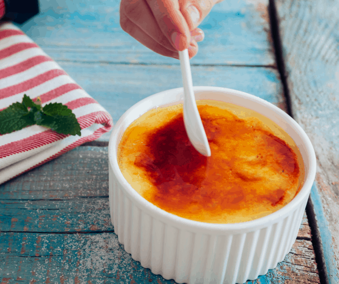 Coconut Crème Brûlée in white ramekin with white spoon