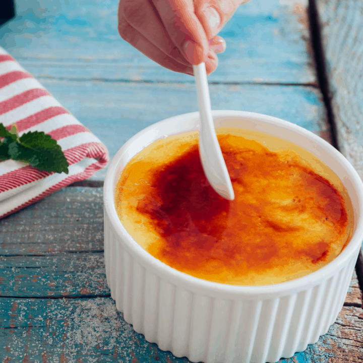 Coconut Crème Brûlée in white ramekin with white spoon