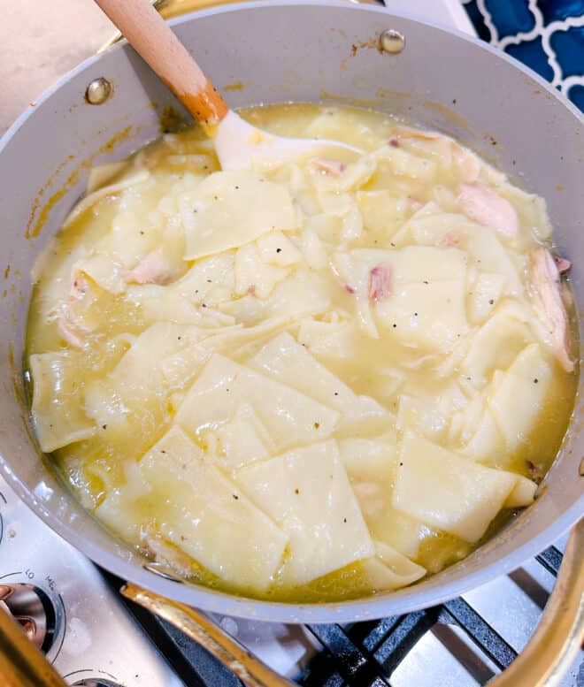 stirring chicken and  dumplings in a large pot