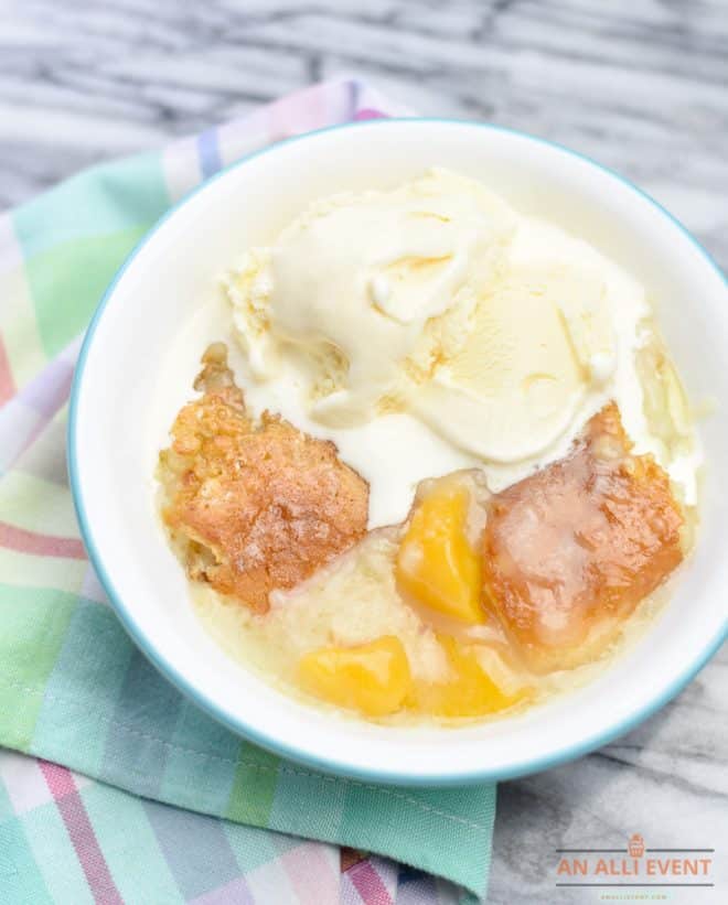 A bowl of homemade southern peach cobbler and vanilla ice cream