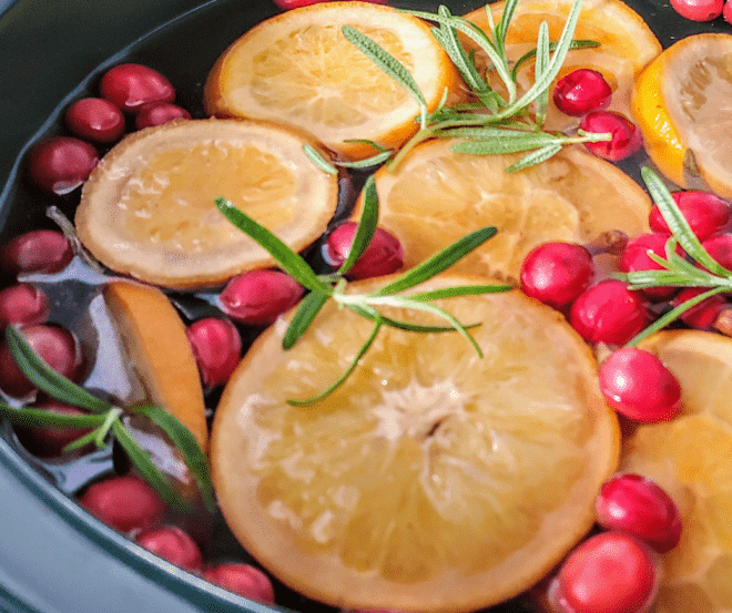 Christmas Scent In A Jar - Slow Cooker filled with lemon slices, cranberries and rosemary sprigs