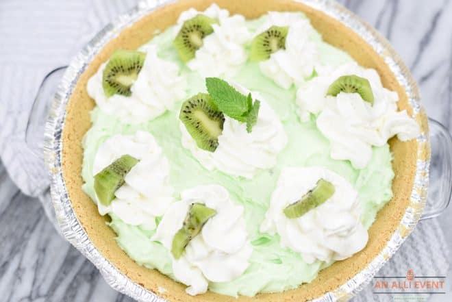 Kiwi Pistachio Pie Topped With Whipped Cream and Kiwi Fruit