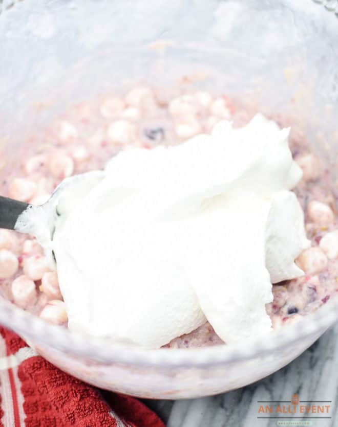 Add whipped topping to cranberry salad