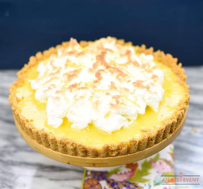 Meyer Lemon Meringue Tart is made with a graham cracker crust and filled with homemade lemon curd. Top with an Italian Meringue and broil for just a minute or two. 