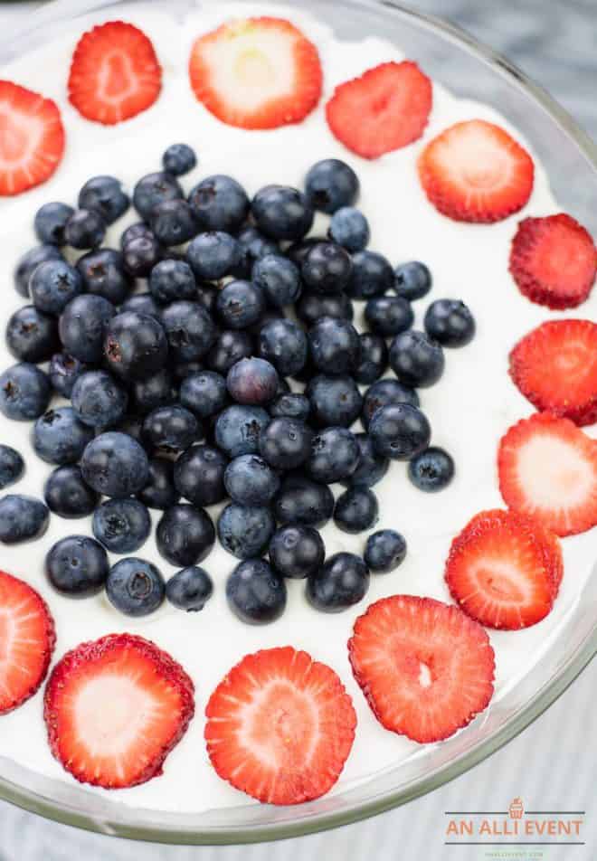 Trifle topped with strawberries and blueberries