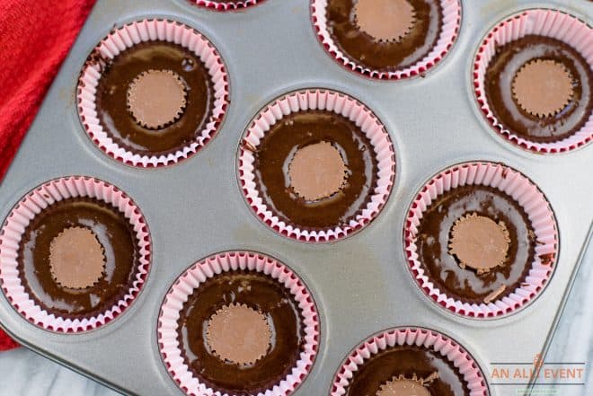 Peanut Butter Cups pressed in center of cupcakes