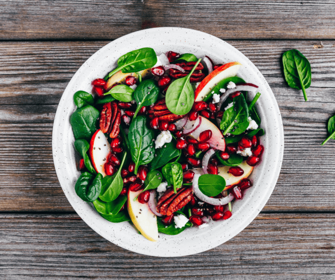 mixed green salad with pomegranate seeds