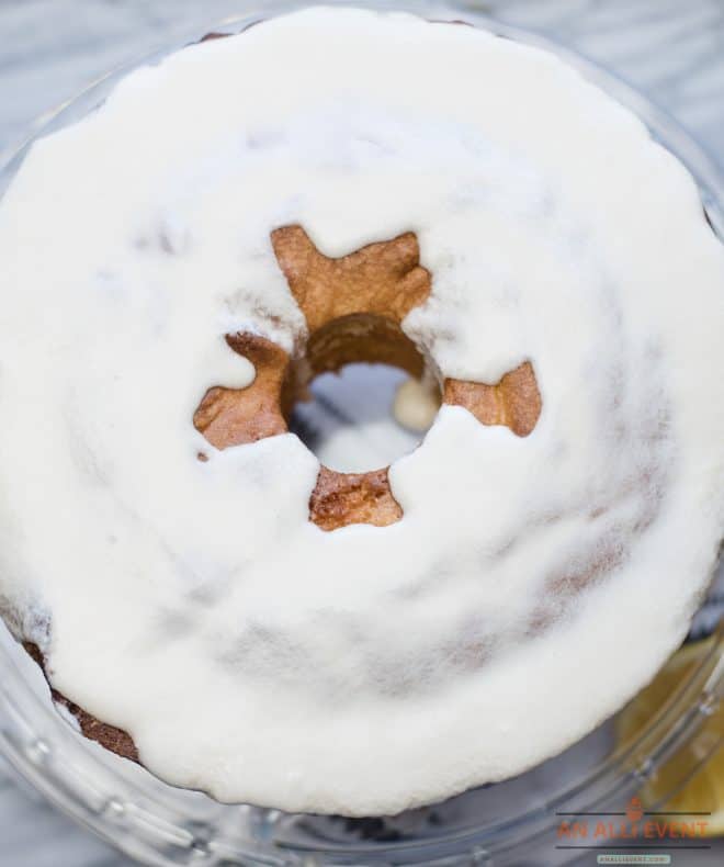 Lemon Pound Cake Topped With Lemon Glaze on a glass cake plate