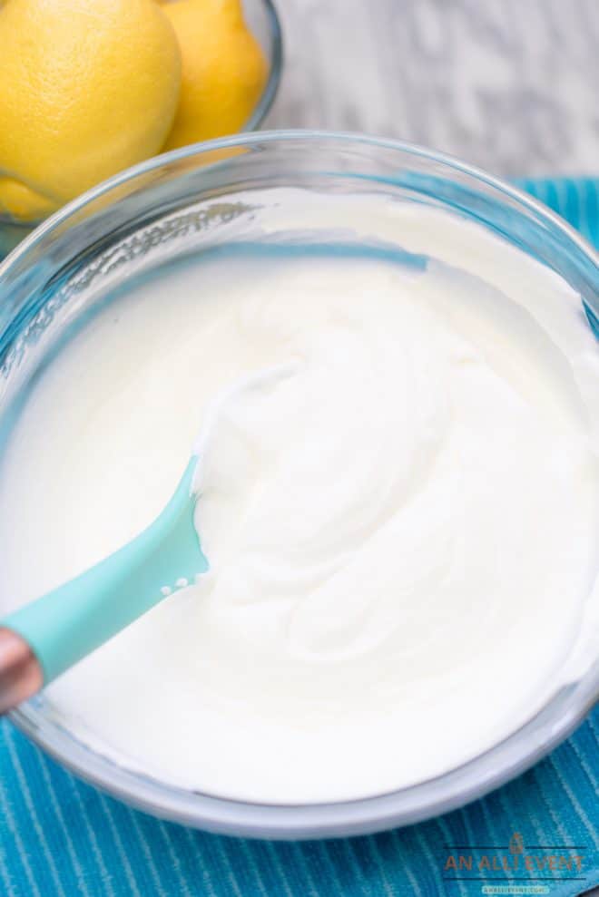 Whipped Cream and Sweetened Condensed Milk and Lemon Juice combined in a glass mixing bowl