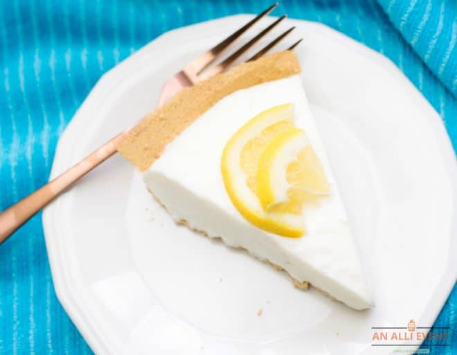 Slice of Lemon Icebox Pie on White Plate on a Blue Cloth