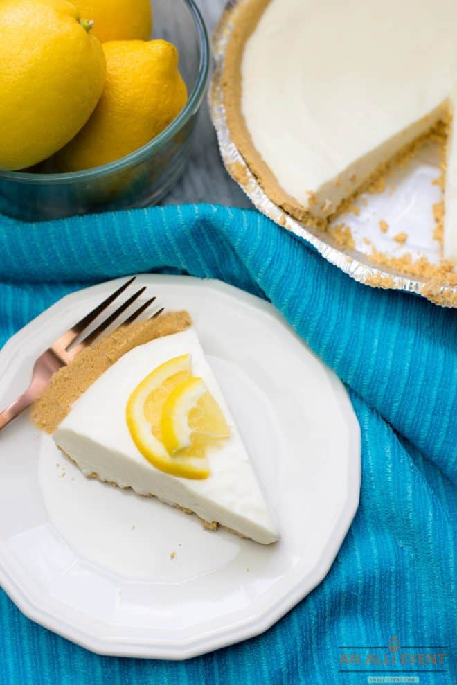 Lemon Pie on a blue cloth and a bowl of lemons