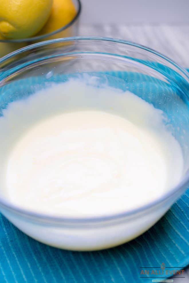 Sweetened Condensed Milk and Lemon Juice mixed together in a clear glass bowl. Step 1 for making Lemon Icebox Pie