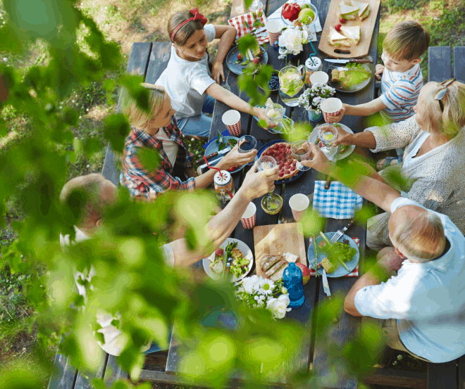 Family Eating Outside at Picnic Table