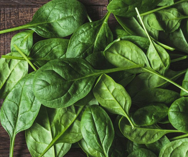 Spinach Leaves on a dark brown wooden countertop