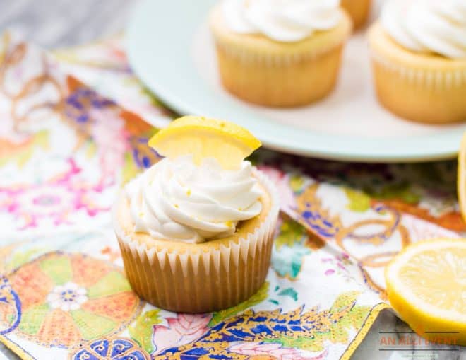 Closeup photos of cupcakes with lemon buttercream frosting and a lemon wedge on top