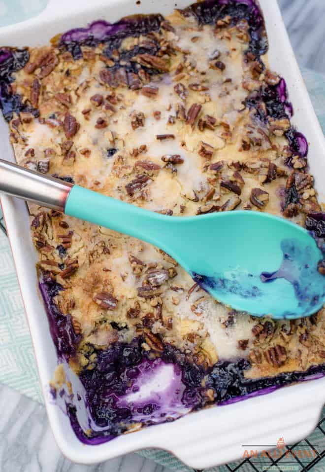 Blueberry Crunch Dump Cake with blue serving spoon