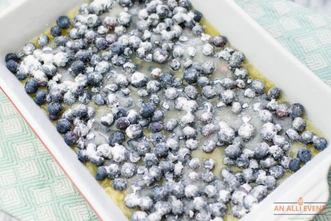 Granulated Sugar sprinkled over fresh blueberries in 13x9 baking dish