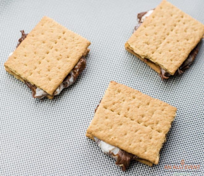 graham crackers sandwiched together with a chocolate marshmallow mixture on the inside