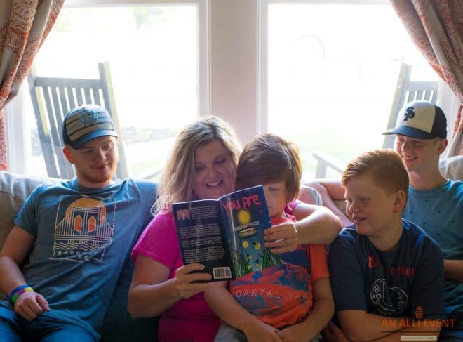 A mom, reading the book You Are, to her four children