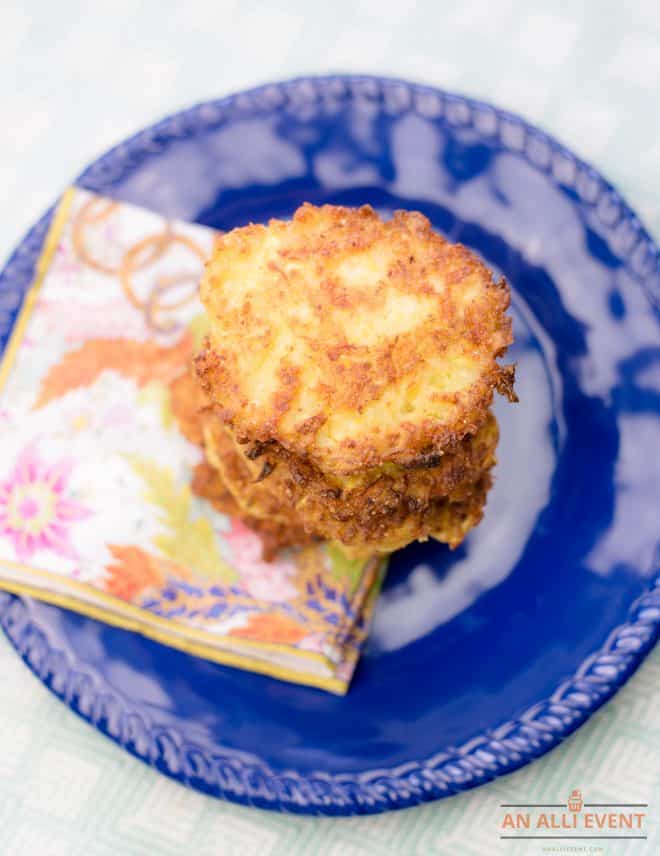 Squash patties stacked on a navy blue plate