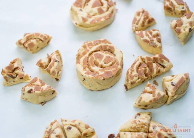 Cinnamon Rolls sliced into quarters on white background