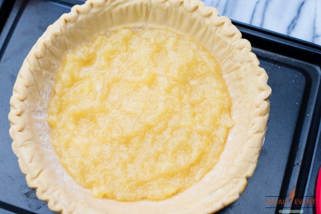 Crushed Pineapple spread over the bottom of a pie crust