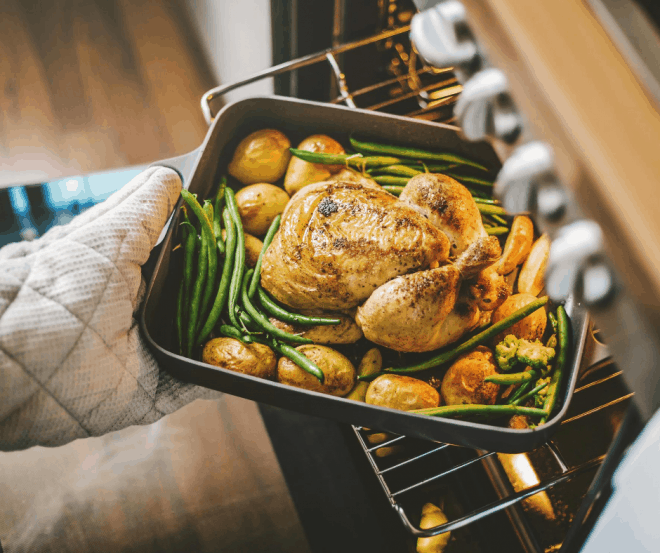 Placing a Roast in the oven showcasing 17 best cookbooks