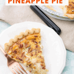 A slice of cream cheese pineapple pie on a white dessert plate with the whole pie in the background