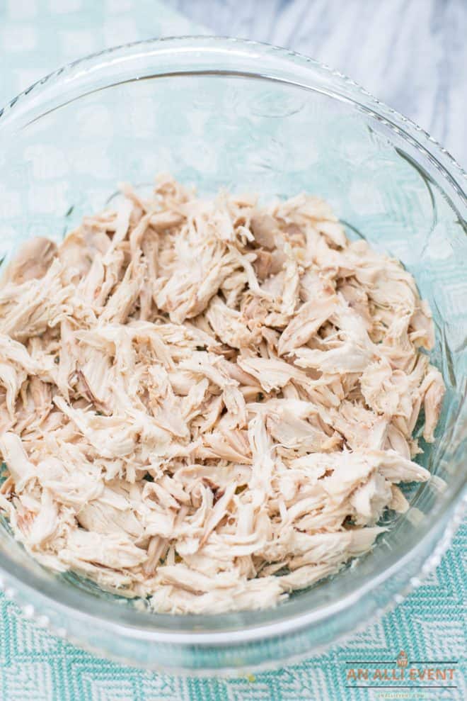 shredded chicken in 2-quart glass casserole dish - first step for making Chicken Pot Pie Casserole