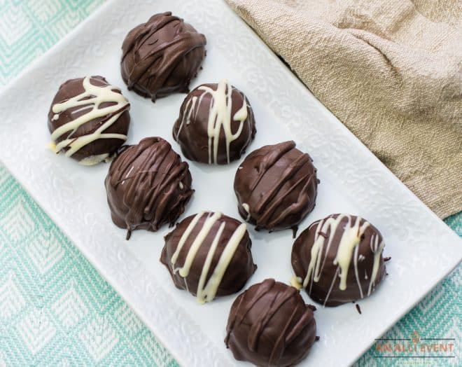 Chocolate Oreo Truffles dipped in chocolate and drizzled with white chocolate