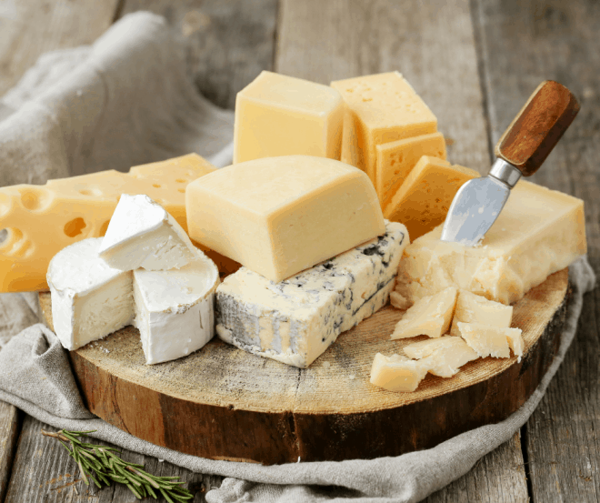 Different types of cheese on a round cheese platter