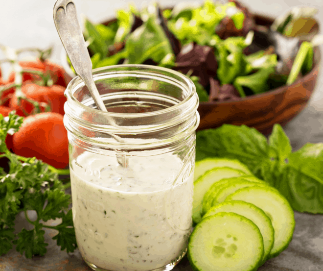 Ranch Dressing in glass jar and green salad