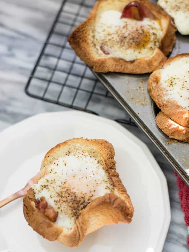 Bacon Egg and Cheese Toast Cups in muffin pan on wire baking rack