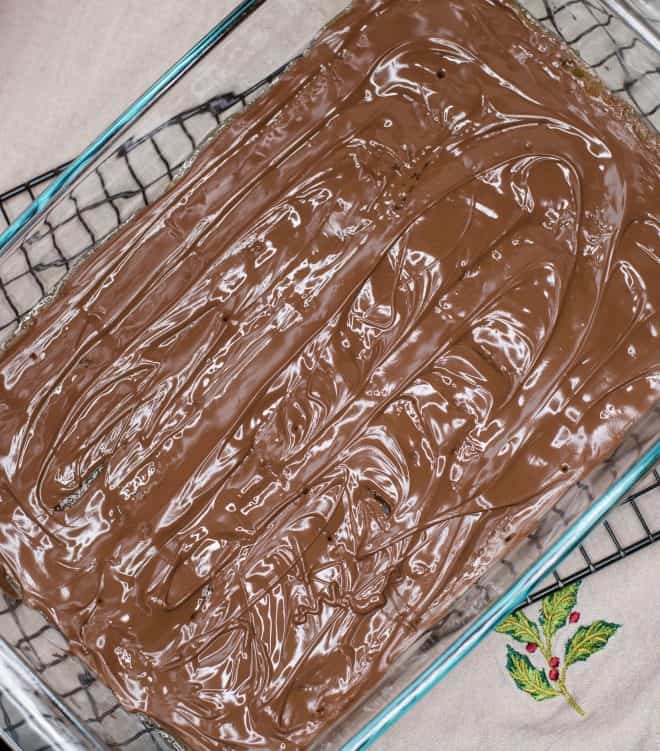 candy bars melted and spread over saltine cracker mixture to make candy