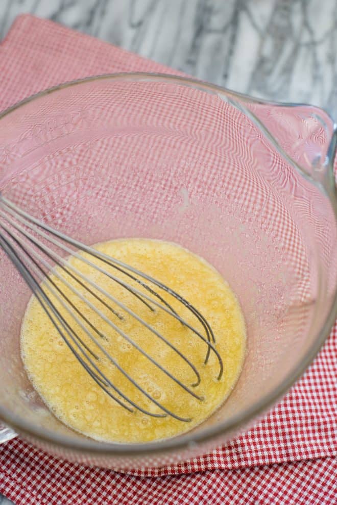 beaten eggs in a medium sized bowl with a whisk 
