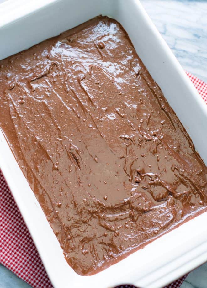 Chocolate brownie batter in a 13x9 baking pan before baking