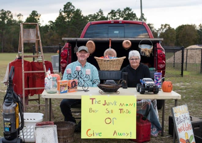 junk man trunk or treat with junk hanging and a sign that says junk, sell, buy or give away