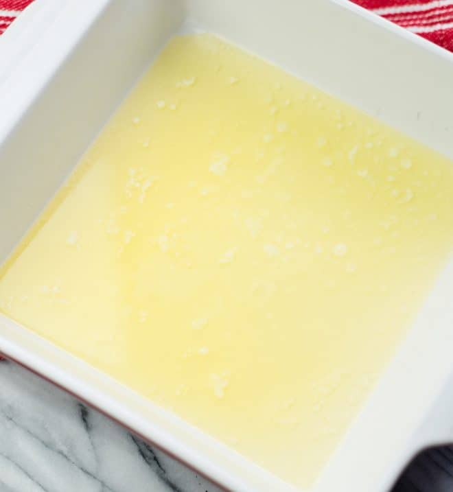 melted butter in a square 8x8 baking pan