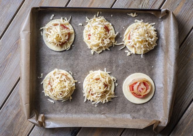 cheese on top of tomato tarts before baking