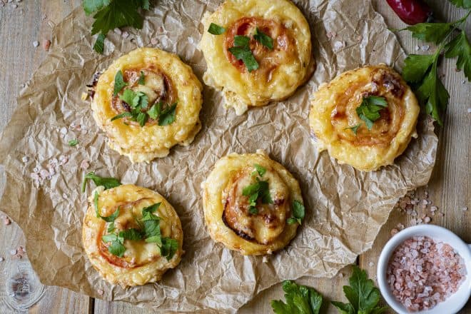Puff Pastry Tomato Tarts on parchment paper